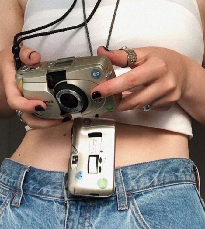 person looking at their vintage Olympus Mju 35mm film camera in Australia