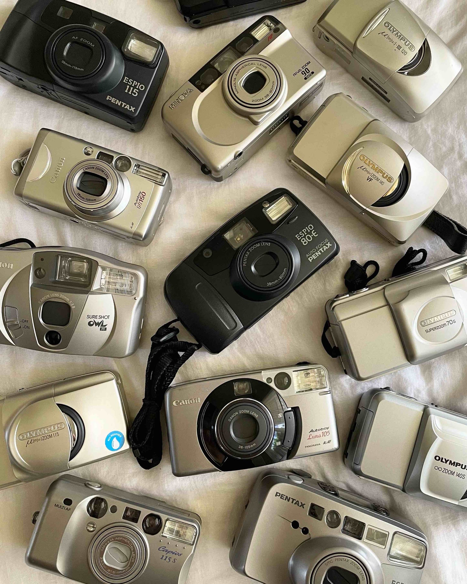 vintage 35mm film cameras in Australia laid out on a white sheet